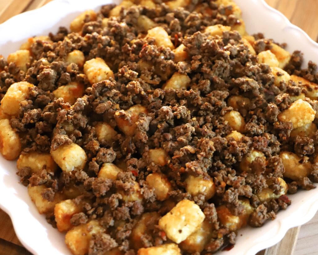 Spoon cooked ground beef evenly over top