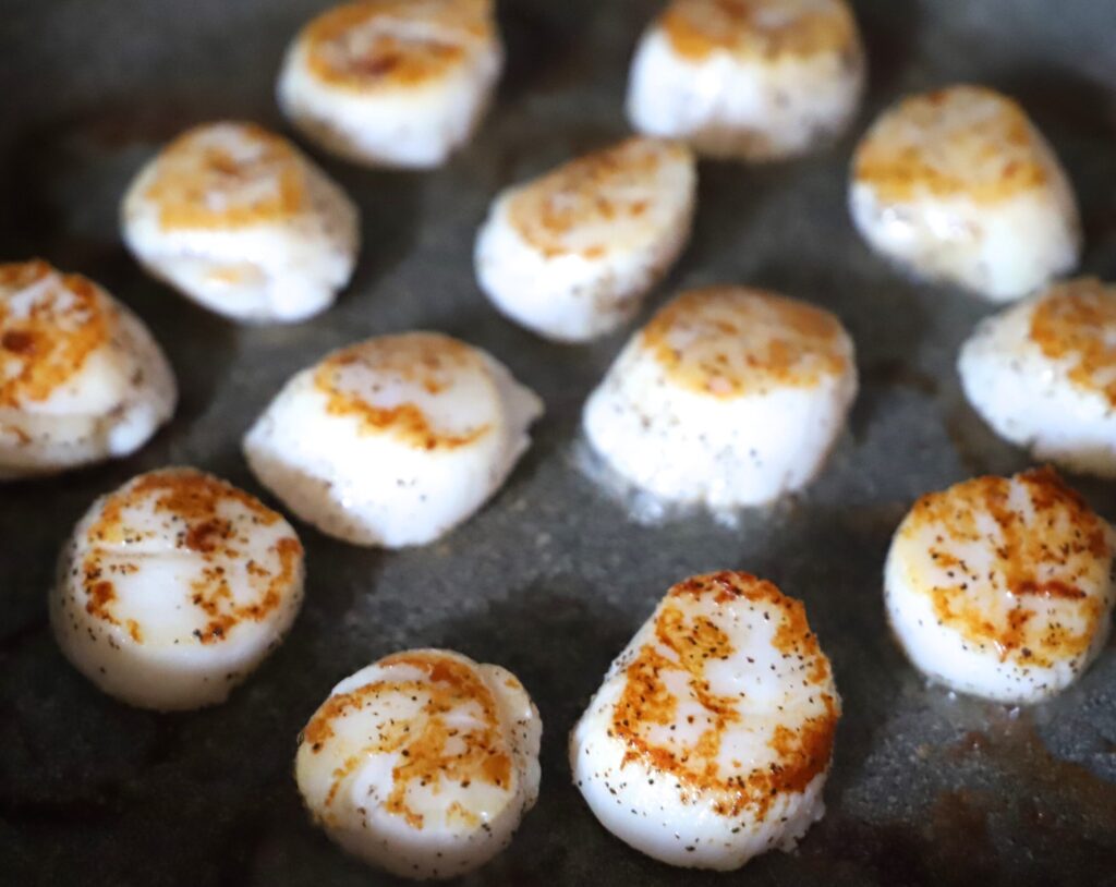 Cook scallops until they start to brown.