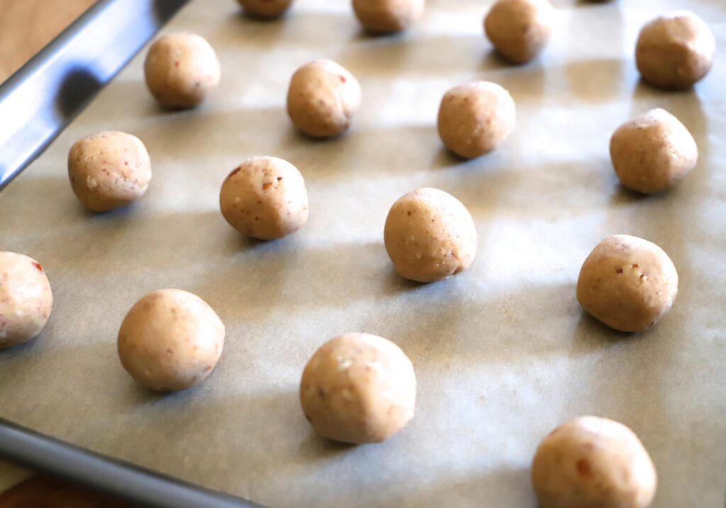 Scoop the dough into even portions, then roll each into an even ball