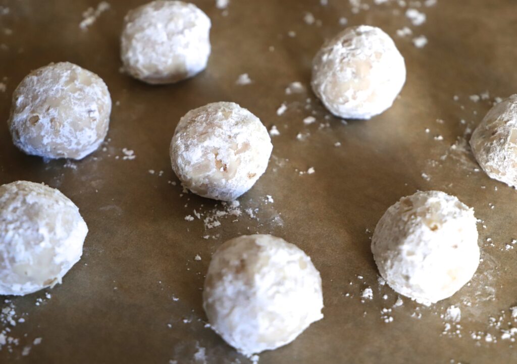 Roll the slightly warm cookies in the remaining powdered sugar.
