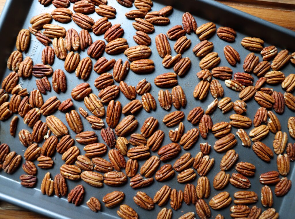 Place the pecans on a rimmed baking sheet and toast for 5 minutes. 