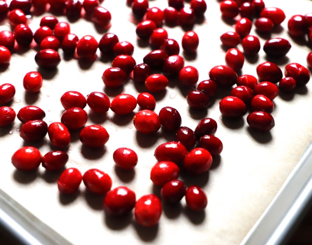 Remove cranberries and transfer to a parchment lined baking sheet.