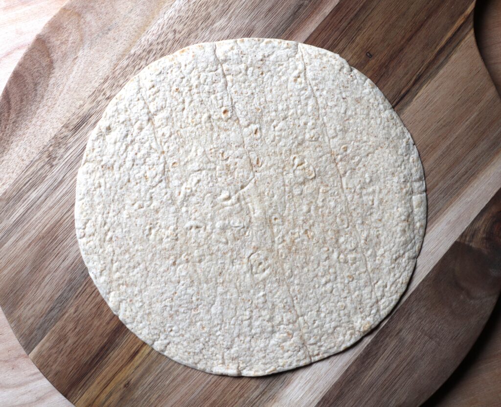 Place tortilla on a flat surface.