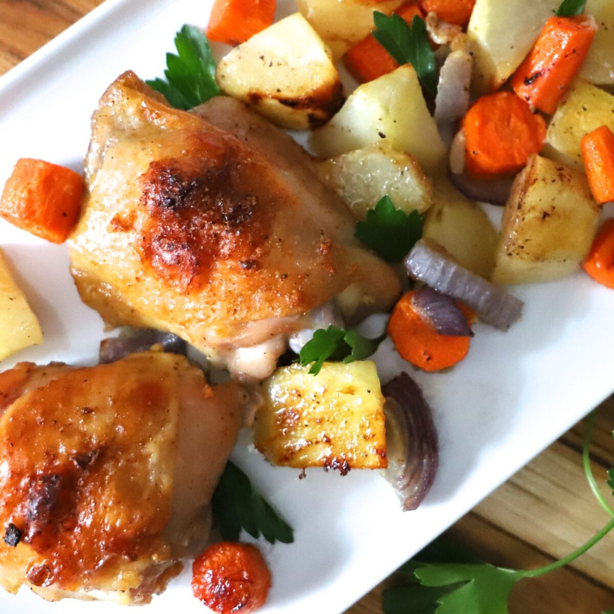 Cajun Baked Chicken Thighs with Vegetables on a plate.