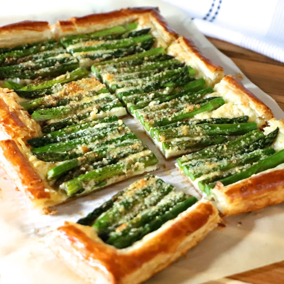 Cheesy Puff Pastry Asparagus Tart on a board